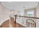 Bright hallway with hardwood floors, elegant staircase, and sunlit window views at 3128 Palmetto Blvd, Edisto Island, SC 29438