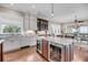 Kitchen featuring marble countertops, custom cabinets, stainless steel appliances, and an island with a beverage cooler at 3128 Palmetto Blvd, Edisto Island, SC 29438