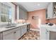 Bright laundry room with gray cabinets, granite countertop, and laundry sink at 3128 Palmetto Blvd, Edisto Island, SC 29438