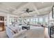 Open-concept living room with coffered ceilings, hardwood floors, and multiple seating areas overlooking the water at 3128 Palmetto Blvd, Edisto Island, SC 29438