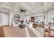 Open-concept living room with coffered ceilings, hardwood floors, and multiple seating areas at 3128 Palmetto Blvd, Edisto Island, SC 29438
