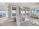 Cozy living room area with white furnishings, water views, and a flat screen television at 3128 Palmetto Blvd, Edisto Island, SC 29438