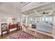 Open-concept living area with hardwood floors, coffered ceiling, and view of dining and living areas at 3128 Palmetto Blvd, Edisto Island, SC 29438