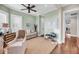Relaxing office space featuring neutral tones, plantation shutters, and lots of natural light at 3128 Palmetto Blvd, Edisto Island, SC 29438
