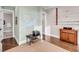 Neutral-toned office space with hardwood floors, a map print, and fishing rod rack adding to the room's unique charm at 3128 Palmetto Blvd, Edisto Island, SC 29438