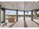 Covered outdoor patio area with hanging swing chairs, and partial pool view at 3128 Palmetto Blvd, Edisto Island, SC 29438