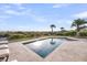 Backyard pool surrounded by a stone patio and lush landscaping at 3128 Palmetto Blvd, Edisto Island, SC 29438