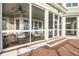 Inviting screened porch with comfortable seating, ceiling fan, and outdoor views at 3128 Palmetto Blvd, Edisto Island, SC 29438