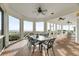 Charming screened porch featuring ample seating, a ceiling fan, and picturesque ocean views at 3128 Palmetto Blvd, Edisto Island, SC 29438