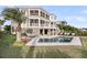 Three-story home with screened in porches, a pool and many lounge chairs at 3128 Palmetto Blvd, Edisto Island, SC 29438