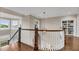 An open staircase with wooden rails, white balusters, and large windows, creating a bright and airy transition space at 3128 Palmetto Blvd, Edisto Island, SC 29438