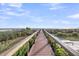 Inviting wooden walkway leads to ocean views and beach access, surrounded by lush landscaping and manicured lawns at 3128 Palmetto Blvd, Edisto Island, SC 29438