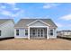 Rear view of a blue house featuring a screened porch with backyard at 321 Abercom Place Dr, Moncks Corner, SC 29461