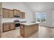 Kitchen with wood cabinets, granite countertops, a stainless microwave and appliances, plus a kitchen island sink at 321 Abercom Place Dr, Moncks Corner, SC 29461