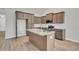 Well-equipped kitchen with wood cabinetry, granite countertops, stainless appliances and an island with a sink at 321 Abercom Place Dr, Moncks Corner, SC 29461