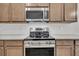Modern stainless steel oven and microwave with granite countertops and wood cabinets for a sleek, functional kitchen design at 321 Abercom Place Dr, Moncks Corner, SC 29461