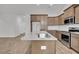Spacious kitchen island with granite countertops, a stainless sink, and wood cabinets, along with stainless appliances at 321 Abercom Place Dr, Moncks Corner, SC 29461