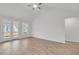 Bright living room featuring wood floors, a ceiling fan and direct access to the backyard through glass doors at 321 Abercom Place Dr, Moncks Corner, SC 29461