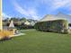 Well-manicured backyard with lush green lawn, a patio dining area, and mature hedges at 3381 Stockdale St, Mount Pleasant, SC 29466