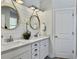 Bright bathroom featuring double sinks, white cabinets, and modern lighting at 3381 Stockdale St, Mount Pleasant, SC 29466