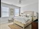 Bright bedroom featuring neutral colors, an upholstered headboard, and two windows for natural light at 3381 Stockdale St, Mount Pleasant, SC 29466