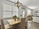 Dining area features a wooden table, woven chairs, and stylish light fixture at 3381 Stockdale St, Mount Pleasant, SC 29466