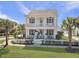 Charming two-story white home featuring a double front porch and a neatly landscaped yard with a white picket fence at 3381 Stockdale St, Mount Pleasant, SC 29466
