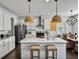 Bright kitchen features a marble island, stainless steel appliances, and stylish wicker pendant lighting at 3381 Stockdale St, Mount Pleasant, SC 29466