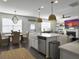 Open-concept kitchen with a breakfast bar island, dining area, and seamlessly connected living space at 3381 Stockdale St, Mount Pleasant, SC 29466