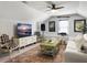Cozy living room with vaulted ceiling, white sofa, TV, and eclectic decor at 3381 Stockdale St, Mount Pleasant, SC 29466