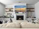 Comfortable living room featuring fireplace, floating shelves, and a large TV at 3381 Stockdale St, Mount Pleasant, SC 29466