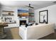 Cozy living room with a fireplace, shiplap accent wall, floating shelves, and comfortable seating at 3381 Stockdale St, Mount Pleasant, SC 29466