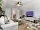 Cozy living room with vaulted ceiling, white sofa, TV, and eclectic decor at 3381 Stockdale St, Mount Pleasant, SC 29466