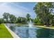 Beautiful pond with a fountain surrounded by lush greenery and mature trees at 3381 Stockdale St, Mount Pleasant, SC 29466