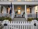 Covered porch with a South Carolina flag, featuring a door with sidelights and an overhead light fixture at 3381 Stockdale St, Mount Pleasant, SC 29466