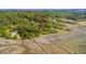 Extensive aerial view of scenic wetlands with a lone pier stretching into the distance, lush foliage, and trees at 3399 Freeman Hill Rd, Johns Island, SC 29455