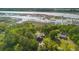 Aerial view of a coastal property showcasing a two-story house, marshlands, and the river at 3399 Freeman Hill Rd, Johns Island, SC 29455