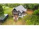 Stunning aerial view of a modern two-story home with wraparound decks and a lush green lawn at 3399 Freeman Hill Rd, Johns Island, SC 29455