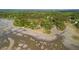 Aerial view of a riverfront property showcasing beautiful marshlands, expansive shoreline, and trees at 3399 Freeman Hill Rd, Johns Island, SC 29455