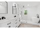 Elegant bathroom boasting a double vanity, frameless glass shower, and stylish, modern fixtures at 3399 Freeman Hill Rd, Johns Island, SC 29455