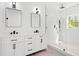 Bright bathroom showcasing a double vanity, walk-in shower, and modern black fixtures at 3399 Freeman Hill Rd, Johns Island, SC 29455