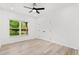 Bright bedroom with a large window offering green views and a modern ceiling fan at 3399 Freeman Hill Rd, Johns Island, SC 29455