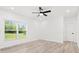 Bright bedroom with large window, light wood floors, and neutral walls for a serene, comfortable space at 3399 Freeman Hill Rd, Johns Island, SC 29455