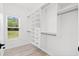 Walk-in closet with custom shelving and drawers, illuminated by natural light from a nearby window at 3399 Freeman Hill Rd, Johns Island, SC 29455