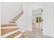 Bright and airy interior featuring stylish stairs and an open doorway leading to a serene view at 3399 Freeman Hill Rd, Johns Island, SC 29455