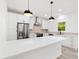 This kitchen features an island, stainless appliances, white cabinets and fixtures, complemented by recessed and pendant lighting at 3399 Freeman Hill Rd, Johns Island, SC 29455