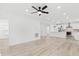 Large living space with light wood flooring and a view of the kitchen with stainless steel appliances and a center island at 3399 Freeman Hill Rd, Johns Island, SC 29455
