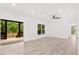 Spacious living area with deck access, ample light, light wood floors, and ceiling fan at 3399 Freeman Hill Rd, Johns Island, SC 29455