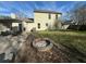 A backyard with a fire pit, a patio with furniture, grassy areas, and the exterior of a two-story home at 3801 Battleview Ct, North Charleston, SC 29420