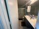 A bathroom features a shower over the toilet, a sink with a wide white countertop, and a white door at 3801 Battleview Ct, North Charleston, SC 29420